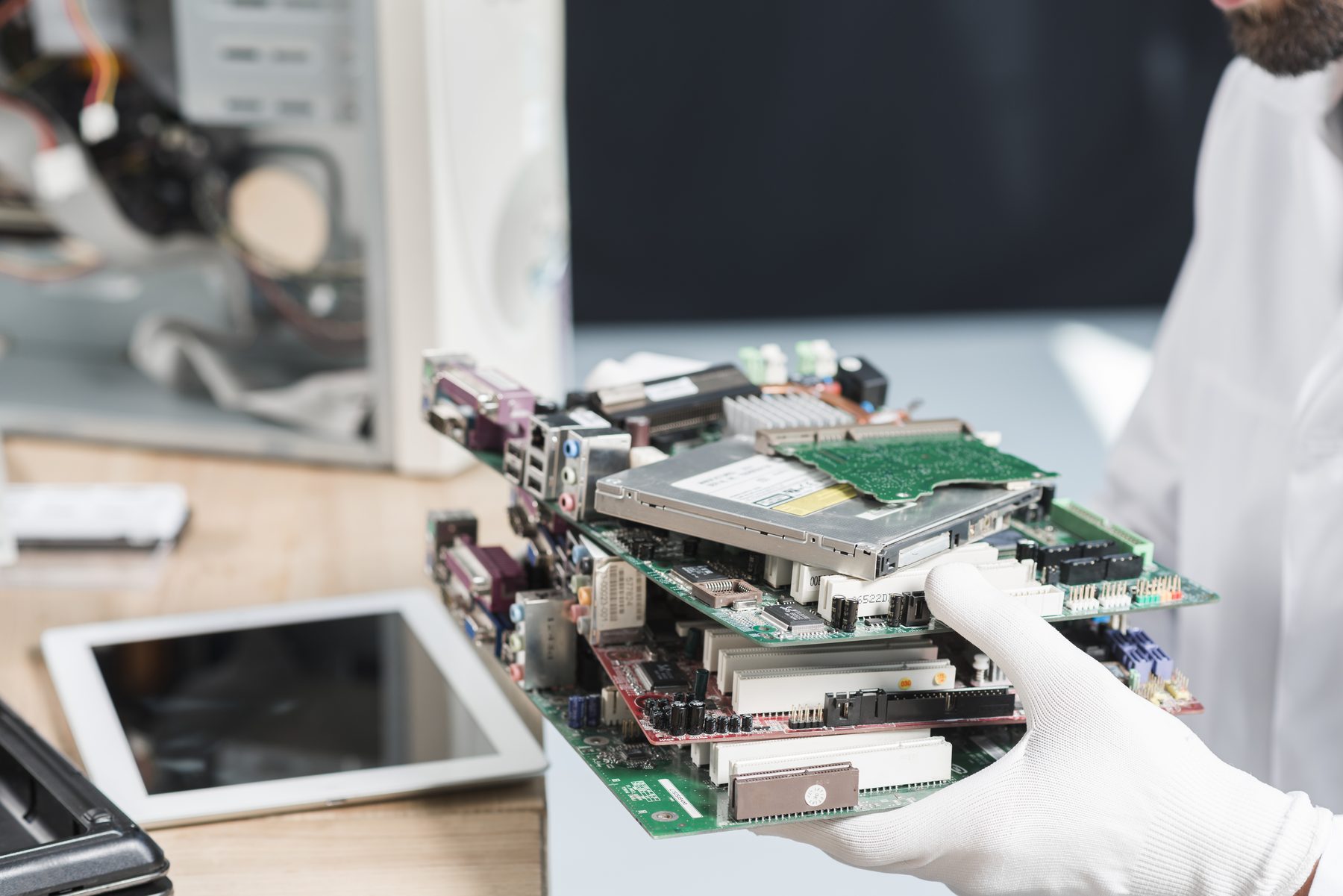 Gloved hand holding circuit boards